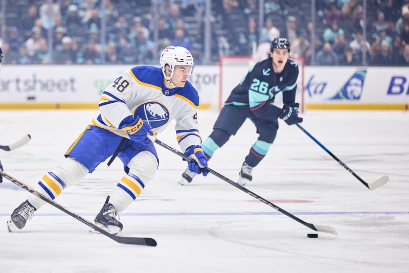 Dec 14, 2025; Seattle, Washington, USA; Buffalo Sabres center Tyson Kozak (48) moves the puck up the ice during the first period against the Seattle Kraken at Climate Pledge Arena. Mandatory Credit: Blake Dahlin-Imagn Images