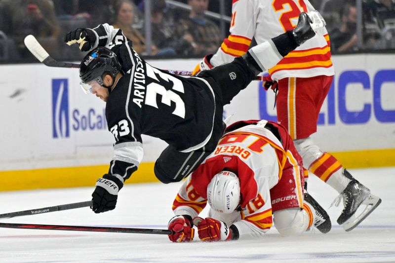 Apr 11, 2024; Los Angeles, California, USA;  Los Angeles Kings right wing Viktor Arvidsson (33) is tripped up by Calgary Flames left wing A.J. Greer (18) in the first period at Crypto.com Arena. Mandatory Credit: Jayne Kamin-Oncea-USA TODAY Sports