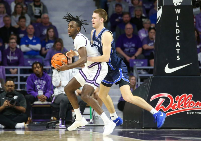 Feb 24, 2024; Manhattan, Kansas, USA; Kansas State Wildcats forward Arthur Maluma (24) is guarded by Brigham Young Cougars forward Noah Waterman (0) during the second half at Bramlage Coliseum. Mandatory Credit: Scott Sewell-USA TODAY Sports