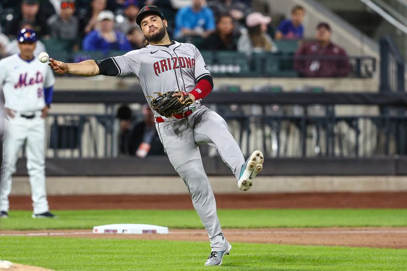 May 30, 2024; New York City, New York, USA; Arizona Diamondbacks third baseman Eugenio Suárez (28) makes an off balanced throw to first base for an out in the fourth inning against the New York Mets at Citi Field. Mandatory Credit: Wendell Cruz-USA TODAY Sports