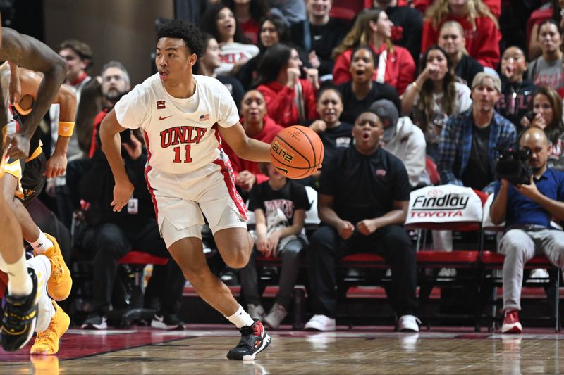 Feb 3, 2024; Las Vegas, Nevada, USA; UNLV Rebels guard Dedan Thomas Jr. (11) dribbles the ball up the court against the Wyoming Cowboys in the first half at Thomas & Mack Center. Mandatory Credit: Candice Ward-USA TODAY Sports