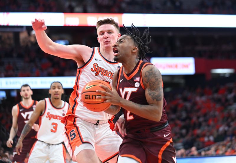 Feb 27, 2024; Syracuse, New York, USA; Virginia Tech Hokies guard MJ Collins (2) tries to get the ball past Syracuse Orange guard Justin Taylor (5) in the first half at the JMA Wireless Dome. Mandatory Credit: Mark Konezny-USA TODAY Sports