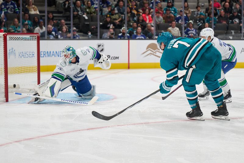 Nov 2, 2024; San Jose, California, USA; San Jose Sharks center Nico Sturm (7) scores a goal against Vancouver Canucks goaltender Kevin Lankinen (32) during the second period at SAP Center at San Jose. Mandatory Credit: Robert Edwards-Imagn Images