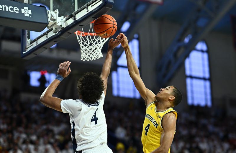 Jan 7, 2024; Philadelphia, Pennsylvania, USA; Michigan Wolverines guard Nimari Burnett (4) defends a shot from Penn State Nittany Lions guard Puff Johnson (4) in the first half at The Palestra. Mandatory Credit: Kyle Ross-USA TODAY Sports