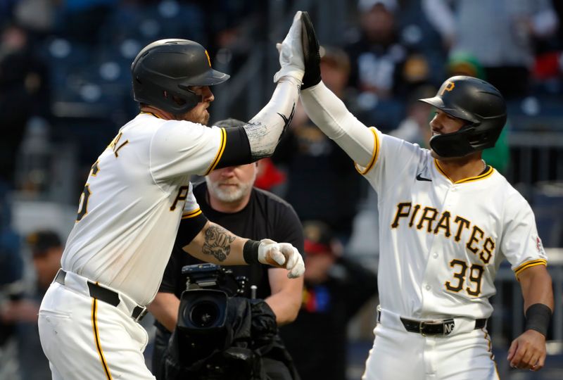 May 11, 2024; Pittsburgh, Pennsylvania, USA; Pittsburgh Pirates catcher Yasmani Grandal (6) celebrates with second baseman Nick Gonzales (39) after hitting a three run home run against the Chicago Cubs during the fifth inning at PNC Park. Mandatory Credit: Charles LeClaire-USA TODAY Sports