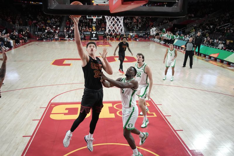 Dec 4, 2024; Los Angeles, California, USA; Southern California Trojans forward Josh Cohen (33) shoots the ball against Oregon Ducks guard TJ Bamba (5) in the second half at Galen Center. Mandatory Credit: Kirby Lee-Imagn ImagesDec 4, 2024; Los Angeles, California, USA; at Galen Center. Mandatory Credit: Kirby Lee-Imagn Images