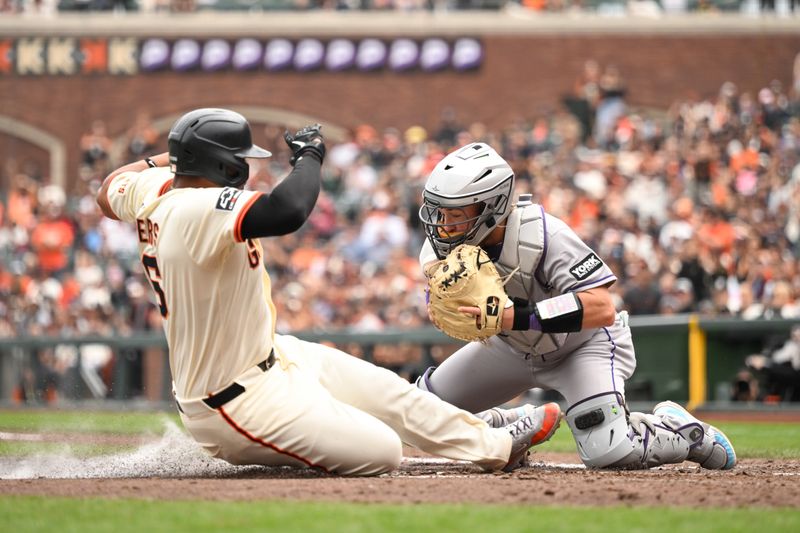 Sep 28, 2025; San Francisco, California, USA;  San Francisco Giants designated hitter Rafael Devers (16) slides home against Colorado Rockies catcher Hunter Goodman (15) in the eighth inning at Oracle Park. Mandatory Credit: Eakin Howard-Imagn Images