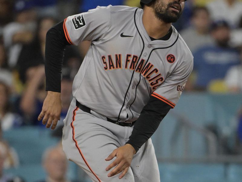 Jul 24, 2024; Los Angeles, California, USA;   San Francisco Giants first baseman LaMonte Wade Jr. (31) grabs his leg after scoring a run in the eighth inning at Dodger Stadium. Mandatory Credit: Jayne Kamin-Oncea-USA TODAY Sports