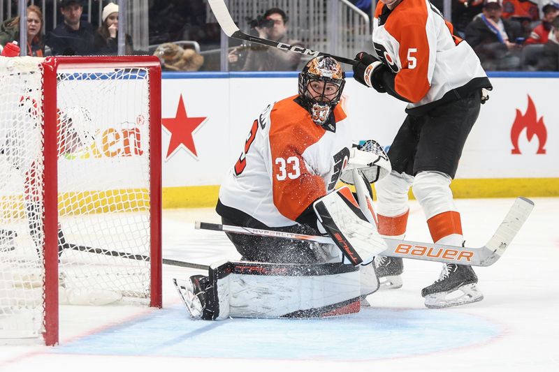 Jan 16, 2025; Elmont, New York, USA;  Philadelphia Flyers goaltender Samuel Ersson (33) watches the play as he defends the net in the second period against the New York Islanders at UBS Arena. Mandatory Credit: Wendell Cruz-Imagn Images