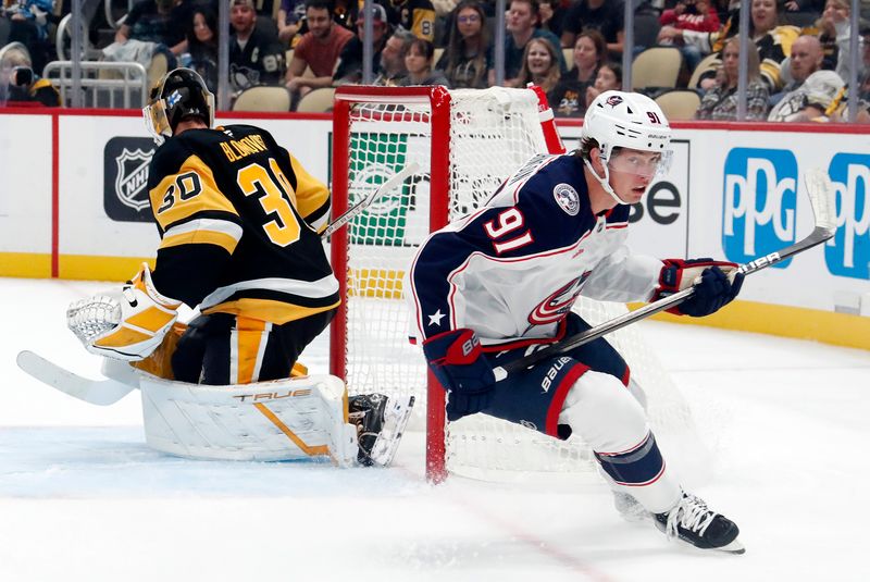 Oct 4, 2024; Pittsburgh, Pennsylvania, USA;  Columbus Blue Jackets center Kent Johnson (91) reacts after scoring a goal on a breakaway against Pittsburgh Penguins goaltender Joel Blomqvist (30) during the second period at PPG Paints Arena. Mandatory Credit: Charles LeClaire-Imagn Images
