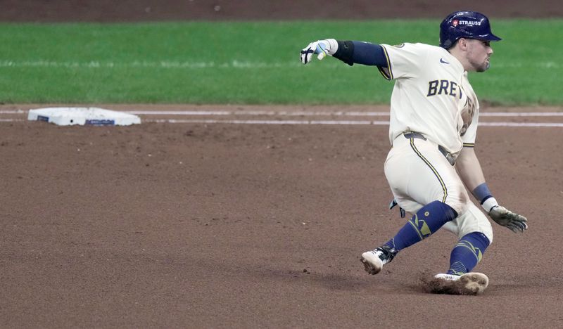 Oct 11, 2025; Milwaukee, Wisconsin, USA; Milwaukee Brewers third baseman Caleb Durbin (21) hits a double during the fourth inning against the Chicago Cubs during game five of the NLDS round for the 2025 MLB playoffs at American Family Field. Mandatory Credit: Mark Hoffman-USA TODAY Network via Imagn Images