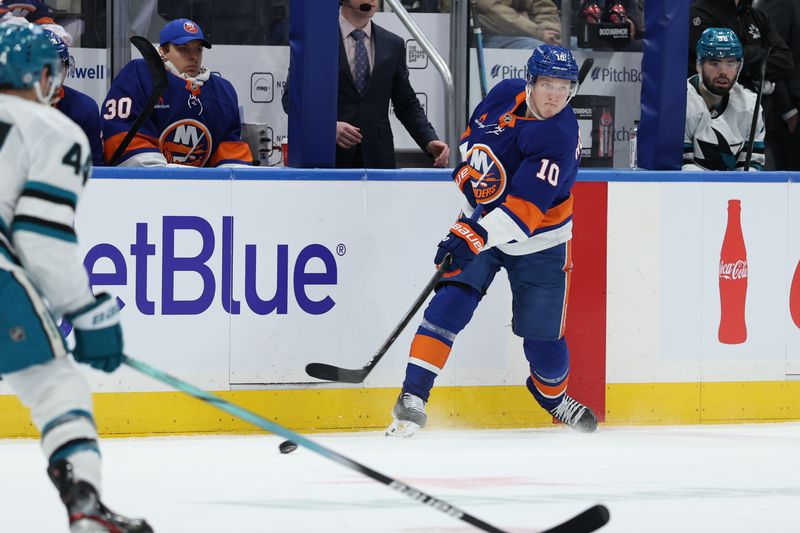 Jan 18, 2025; Elmont, New York, USA; New York Islanders right wing Simon Holmstrom (10) make a pass against the San Jose Sharks during the second period at UBS Arena. Mandatory Credit: Thomas Salus-Imagn Images