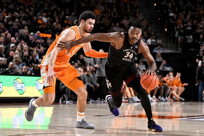 Feb 21, 2023; College Station, Texas, USA;  Texas A&M Aggies forward Julius Marble (34) drives to the basket against Tennessee Volunteers forward Olivier Nkamhoua (13) during the second half at Reed Arena. Mandatory Credit: Maria Lysaker-USA TODAY Sports