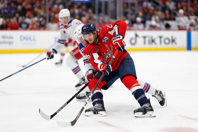 Oct 29, 2024; Washington, District of Columbia, USA; Washington Capitals center Nic Dowd (26) skates with the puck as New York Rangers defenseman Adam Fox (23) defends in the third period at Capital One Arena. Mandatory Credit: Geoff Burke-Imagn Images