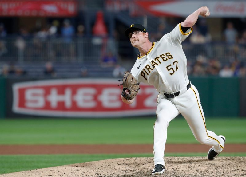 Aug 26, 2024; Pittsburgh, Pennsylvania, USA;  Pittsburgh Pirates relief pitcher Brady Feigl (52) pitches in his major  league debut against the Chicago Cubs during the eighth inning at PNC Park. Mandatory Credit: Charles LeClaire-USA TODAY Sports