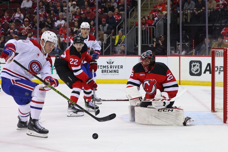 Nov 7, 2024; Newark, New Jersey, USA; New Jersey Devils goaltender Jacob Markstrom (25) makes a save against the Montreal Canadiens during the first period at Prudential Center. Mandatory Credit: Ed Mulholland-Imagn Images