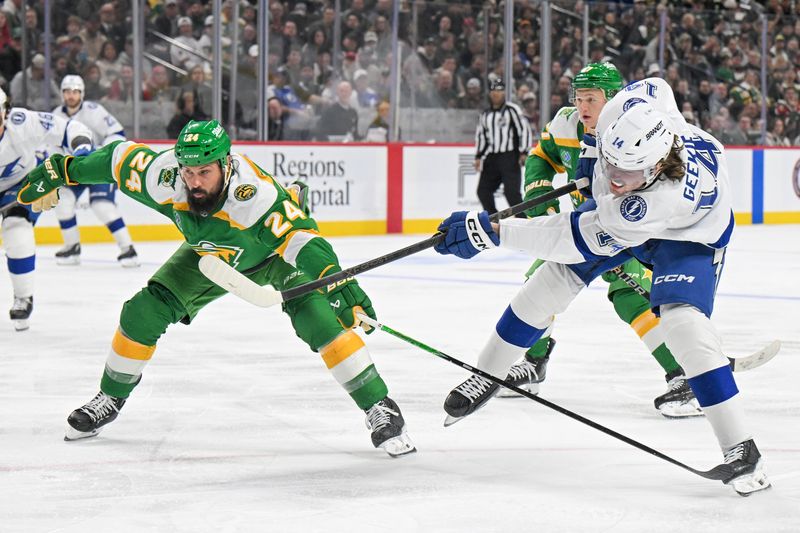 Mar 3, 2026; Saint Paul, Minnesota, USA;  Tampa Bay Lightning forward Conor Geekie (14) shoots the puck as Minnesota Wild defensemen Zach Bogosian (24) back-checks during the third period at Grand Casino Arena. Mandatory Credit: Nick Wosika-Imagn Images