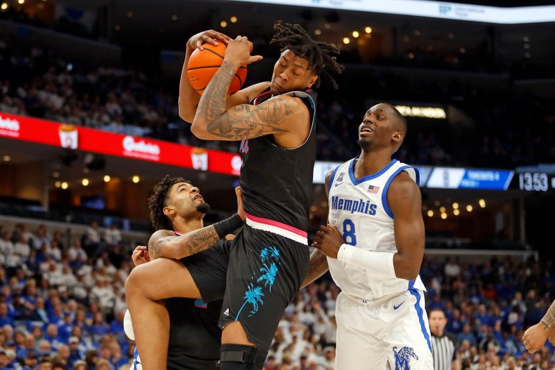 Feb 25, 2024; Memphis, Tennessee, USA; Florida Atlantic Owls forward Giancarlo Rosado (3) collects a rebound over Memphis Tigers forward David Jones (8) during the first half at FedExForum. Mandatory Credit: Petre Thomas-USA TODAY Sports