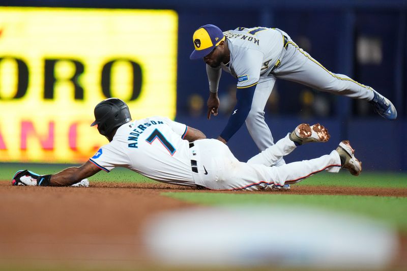 May 22, 2024; Miami, Florida, USA; Milwaukee Brewers third baseman Andruw Monasterio (14) tags out Miami Marlins short stop Tim Anderson (7) during the fifth inning at loanDepot Park. Mandatory Credit: Rich Storry-USA TODAY Sports