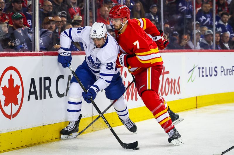 Feb 2, 2026; Calgary, Alberta, CAN; Toronto Maple Leafs center John Tavares (91) and Calgary Flames defenseman Kevin Bahl (7) battle for the puck during the first period at Scotiabank Saddledome. Mandatory Credit: Sergei Belski-Imagn Images