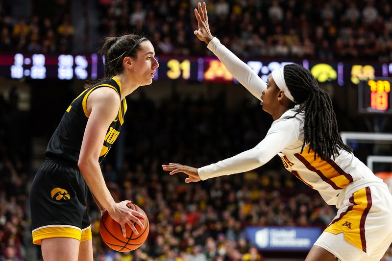 Feb 28, 2024; Minneapolis, Minnesota, USA; Iowa Hawkeyes guard Caitlin Clark (22) controls the ball as Minnesota Golden Gophers guard Janay Sanders (30) defends during the second half at Williams Arena. Mandatory Credit: Matt Krohn-USA TODAY Sports