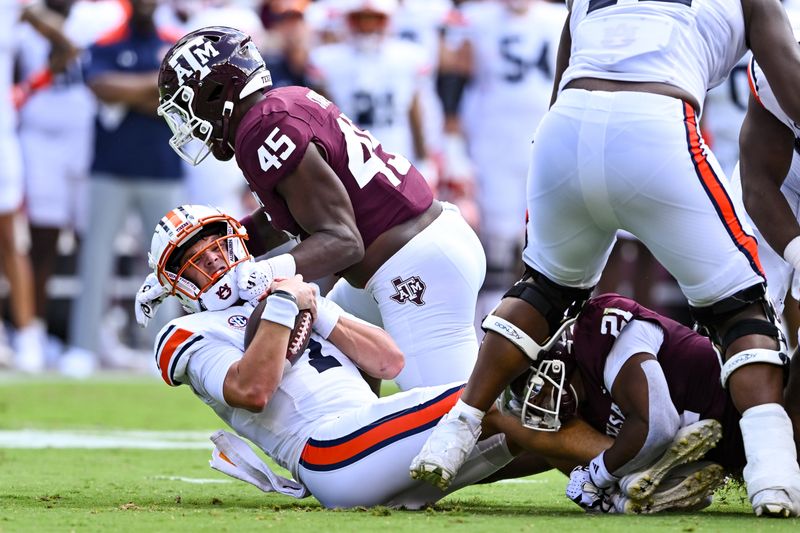 Sep 23, 2023; College Station, Texas, USA; Texas A&M Aggies linebacker Edgerrin Cooper (45) sacks Auburn Tigers quarterback Payton Thorne (1) during the first half at Kyle Field. Mandatory Credit: Maria Lysaker-USA TODAY Sports