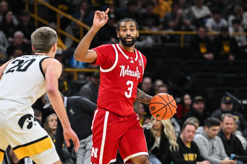 Jan 7, 2025; Iowa City, Iowa, USA; Nebraska Cornhuskers guard Brice Williams (3) controls the ball as Iowa Hawkeyes forward Payton Sandfort (20) defends during the first half at Carver-Hawkeye Arena. Mandatory Credit: Jeffrey Becker-Imagn Images