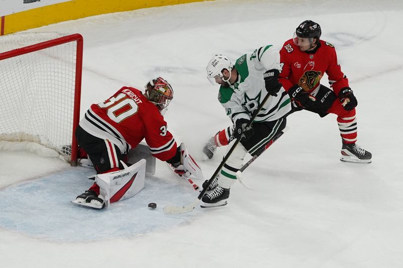Jan 1, 2026; Chicago, Illinois, USA; Chicago Blackhawks goaltender Spencer Knight (30) makes a save on Dallas Stars center Colin Blackwell (15) during the second period at United Center. Mandatory Credit: David Banks-Imagn Images