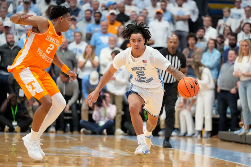 Nov 29, 2023; Chapel Hill, North Carolina, USA; North Carolina Tar Heels guard Elliot Cadeau (2) on the fast break as Tennessee Volunteers guard Jordan Gainey (2) defends in the second half at Dean E. Smith Center. Mandatory Credit: Bob Donnan-USA TODAY Sports