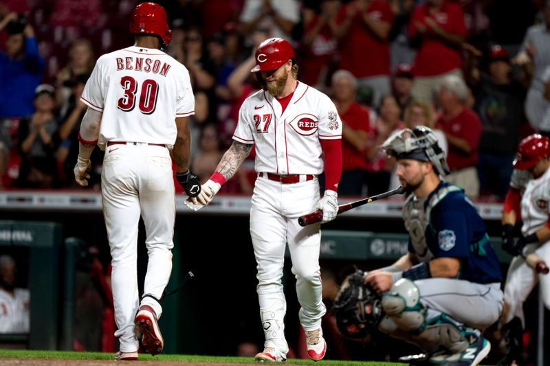 Sep 6, 2023; Cincinnati, Ohio, USA; Cincinnati Reds right fielder Will Benson (30) high fives designated hitter Jake Fraley (27) after hitting a solo home run in the ninth inning of the MLB baseball game between the Cincinnati Reds and the Seattle Mariners at Great American Ball Park. Mandatory Credit: Albert Cesare-USA TODAY Sports