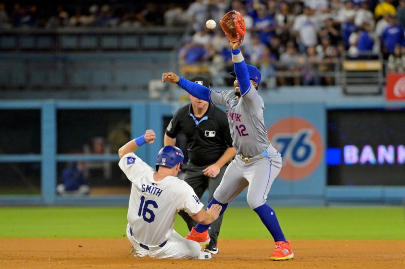 Oct 20, 2024; Los Angeles, California, USA; Los Angeles Dodgers catcher Will Smith (16) is safe at second against New York Mets shortstop Francisco Lindor (12) in the sixth inning during game six of the NLCS for the 2024 MLB playoffs at Dodger Stadium. Mandatory Credit: Jayne Kamin-Oncea-Imagn Images