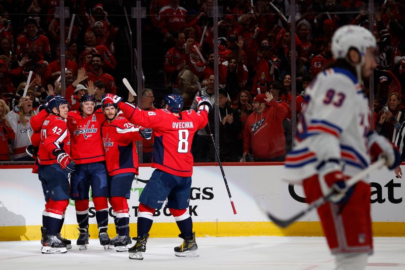 Apr 26, 2024; Washington, District of Columbia, USA;Washington Capitals defenseman John Carlson (74) celebrates with teammates after scoring a goal against the New York Rangers in the first period in game three of the first round of the 2024 Stanley Cup Playoffs at Capital One Arena. Mandatory Credit: Geoff Burke-USA TODAY Sports