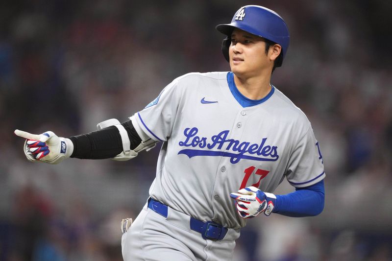 May 6, 2025; Miami, Florida, USA;  Los Angeles Dodgers designated hitter Shohei Ohtani (17) points to his dugout after hitting a home run against the Miami Marlins in the sixth inning at loanDepot Park. Mandatory Credit: Jim Rassol-Imagn Images