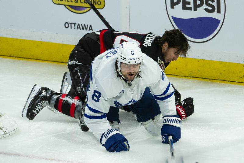 May 1, 2025; Ottawa, Ontario, CAN; Ottawa Senators center Dylan Cozens (24) loses his helmet after colliding with Toronto Maple Leafs defenseman Christopher Tanev (8) in game six of the first round of the 2025 Stanley Cup Playoffs at Canadian Tire Centre. Mandatory Credit: Marc DesRosiers-Imagn Images