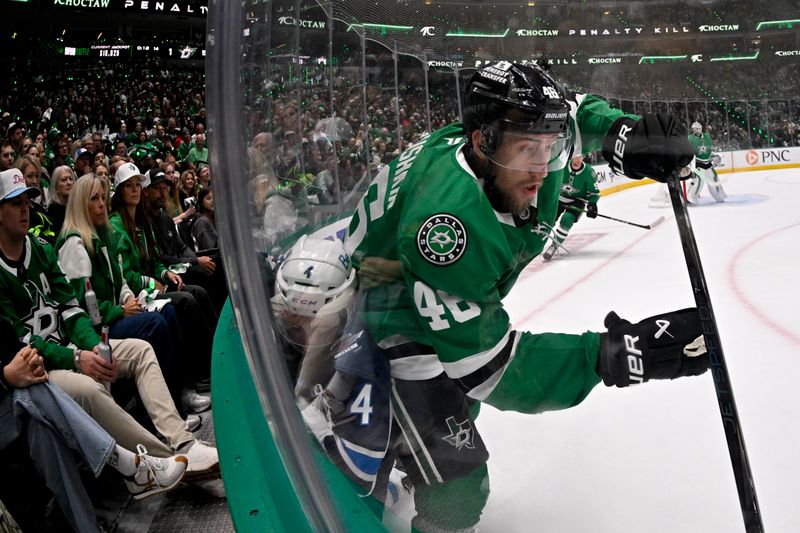 May 11, 2025; Dallas, Texas, USA; Dallas Stars defenseman Ilya Lyubushkin (46) clears the puck in front of Winnipeg Jets defenseman Neal Pionk (4) during the first period in game three of the second round of the 2025 Stanley Cup Playoffs at American Airlines Center. Mandatory Credit: Jerome Miron-Imagn Images