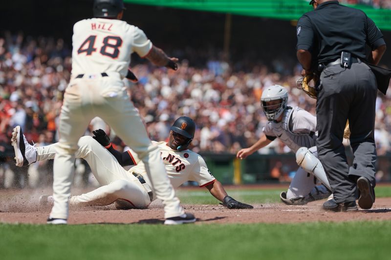 Jul 28, 2024; San Francisco, California, USA; San Francisco Giants designated hitter Jorge Soler (2) slides into home to score a run against Colorado Rockies catcher Jacob Stallings (25) as San Francisco Giants outfielder Derek Hill (48) and home plate umpire Laz Diaz (63) watch the play during the sixth inning at Oracle Park. Mandatory Credit: Robert Edwards-USA TODAY Sports