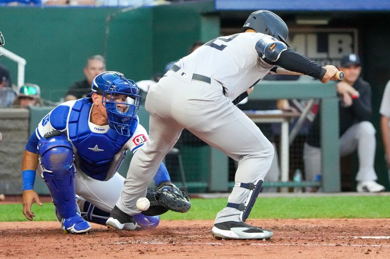 Jun 10, 2024; Kansas City, Missouri, USA; New York Yankees designated hitter Juan Soto (22) is hit by a pitch as Kansas City Royals catcher Freddy Fermin (34) tries to catch the pitch in the third inning at Kauffman Stadium. Mandatory Credit: Denny Medley-USA TODAY Sports