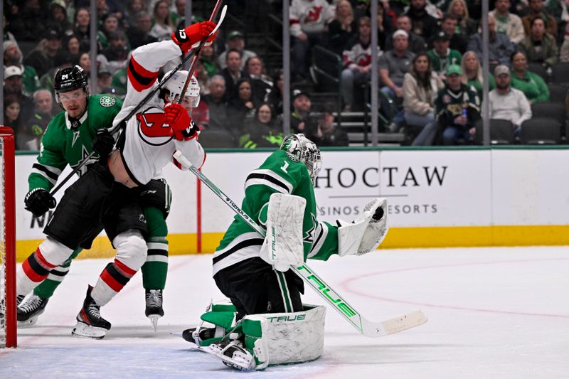Mar 4, 2025; Dallas, Texas, USA; Dallas Stars goaltender Casey DeSmith (1) makes a glove save in front of New Jersey Devils center Dawson Mercer (91) during the first period at the American Airlines Center. Mandatory Credit: Jerome Miron-Imagn Images