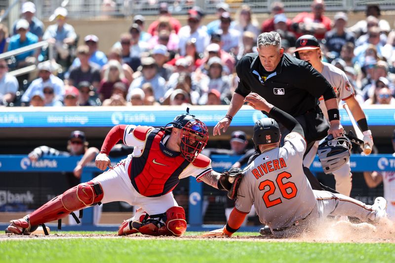 May 8, 2025; Minneapolis, Minnesota, USA; Minnesota Twins catcher Christian Vazquez (8) tags out Baltimore Orioles third baseman Emmanuel Rivera (26) at home plate during the sixth inning at Target Field. Mandatory Credit: Matt Krohn-Imagn Images