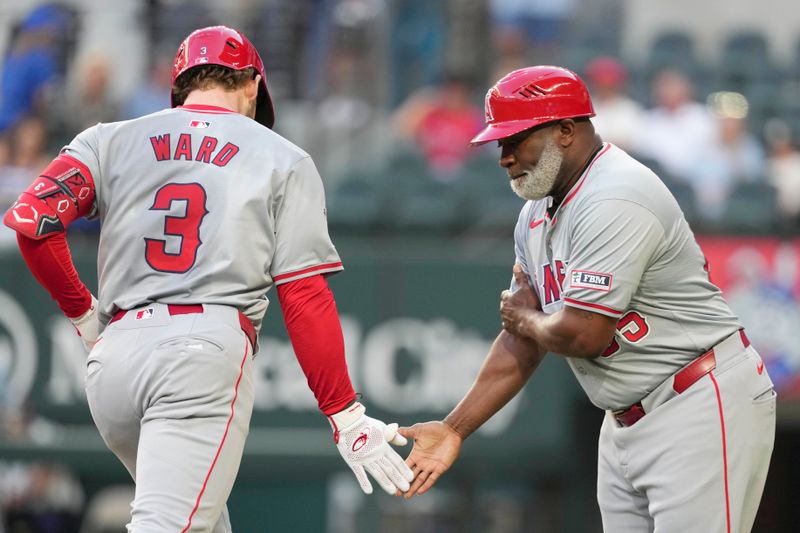 Sep 7, 2024; Arlington, Texas, USA; Los Angeles Angels left fielder Taylor Ward (3) celebrates his home run with third base coach Eric Young Sr. (85) against the Texas Rangers during the first inning at Globe Life Field. Mandatory Credit: Jim Cowsert-Imagn Images