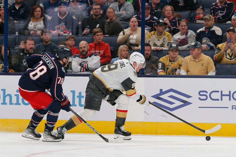 Mar 4, 2024; Columbus, Ohio, USA; Vegas Golden Knights center Jack Eichel (9) reaches for a loose puck as Columbus Blue Jackets defenseman Damon Severson (78) defends during the first period at Nationwide Arena. Mandatory Credit: Russell LaBounty-USA TODAY Sports