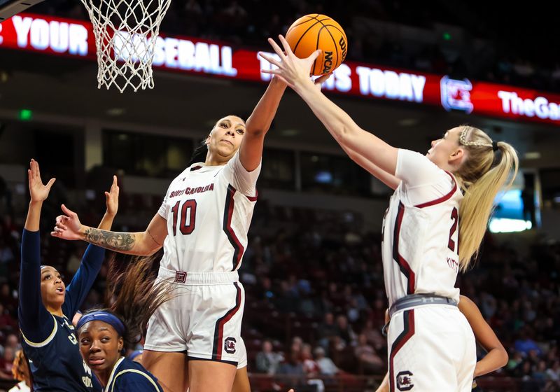 Dec 18, 2022; Columbia, South Carolina, USA; South Carolina Gamecocks center Kamilla Cardoso (10) and South Carolina Gamecocks forward Chloe Kitts (21) attempt to rebound against the Charleston Southern Buccaneers in the first half at Colonial Life Arena. Mandatory Credit: Jeff Blake-USA TODAY Sports