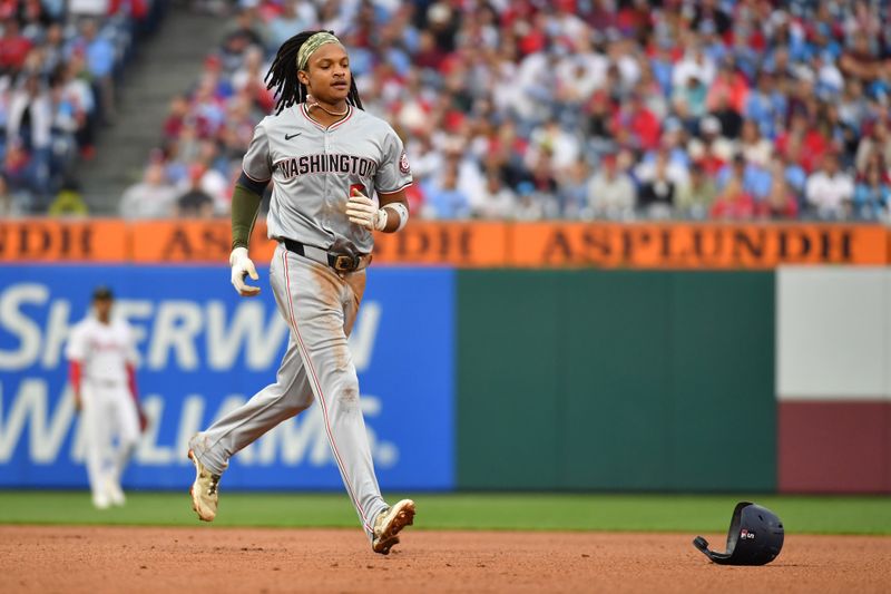 May 19, 2024; Philadelphia, Pennsylvania, USA; Washington Nationals shortstop CJ Abrams (5) retrieves his helmet after RBI single during the fifth inning against the Philadelphia Phillies at Citizens Bank Park. Mandatory Credit: Eric Hartline-USA TODAY Sports