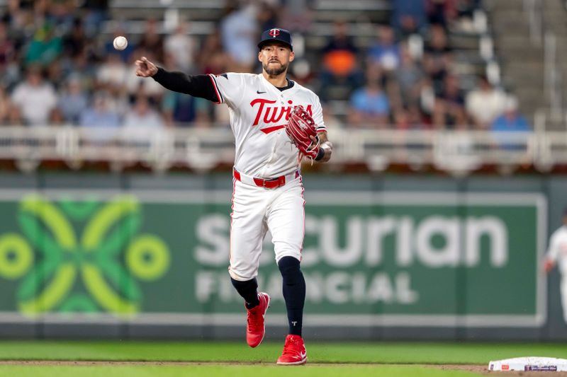 May 8, 2024; Minneapolis, Minnesota, USA; Minnesota Twins shortstop Carlos Correa (4) throws the ball to first base for an out against the Seattle Mariners in the ninth inning at Target Field. Mandatory Credit: Jesse Johnson-USA TODAY Sports