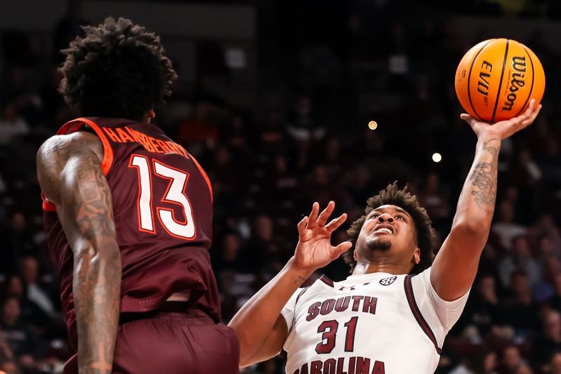 Dec 2, 2025; Columbia, South Carolina, USA; South Carolina Gamecocks forward Elijah Strong (31) shoots over Virginia Tech Hokies forward Amani Hansberry (13) in the first half at Colonial Life Arena. Mandatory Credit: Jeff Blake-Imagn Images