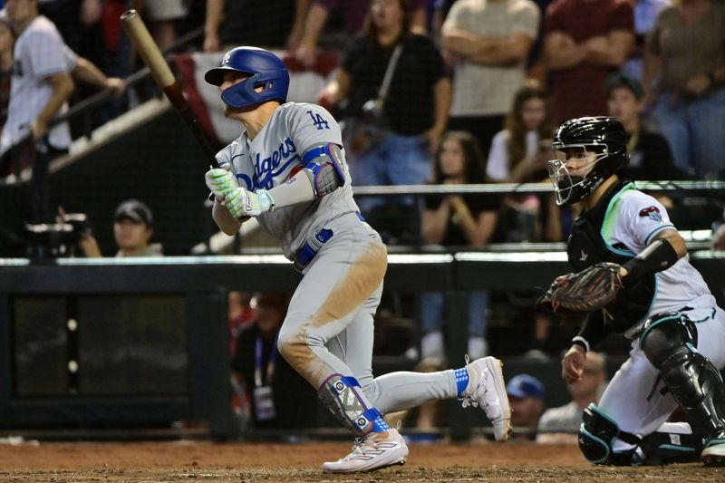 Oct 11, 2023; Phoenix, Arizona, USA; Los Angeles Dodgers shortstop Enrique Hernandez (8) hits a RBI single against the Arizona Diamondbacks in the seventh inning for game three of the NLDS for the 2023 MLB playoffs at Chase Field. Mandatory Credit: Matt Kartozian-USA TODAY Sports