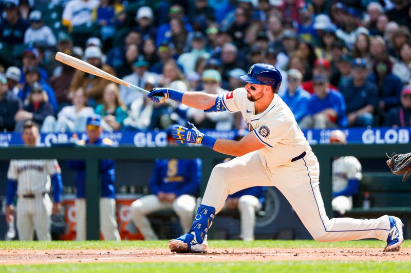 Apr 13, 2025; Seattle, Washington, USA; Seattle Mariners catcher Cal Raleigh (29) hits a two-run home run against the Texas Rangers during the first inning at T-Mobile Park. Mandatory Credit: Joe Nicholson-Imagn Images