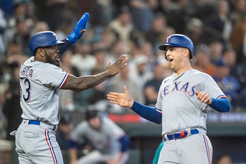 Sep 30, 2023; Seattle, Washington, USA; Texas Rangers third baseman Josh Jung (6) is congratulated by right fielder Adolis Garcia (53) after scoring a run against the Seattle Mariners during the third inning at T-Mobile Park. Mandatory Credit: Stephen Brashear-USA TODAY Sports