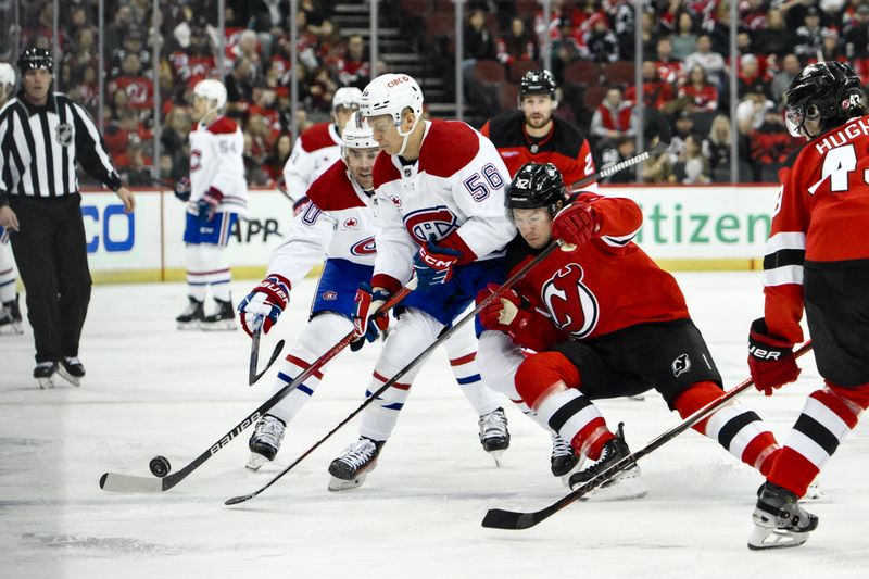 Feb 24, 2024; Newark, New Jersey, USA; Montreal Canadiens right wing Jesse Ylonen (56) skates with the puck while being defended by New Jersey Devils center Curtis Lazar (42) during the first period at Prudential Center. Mandatory Credit: John Jones-USA TODAY Sports