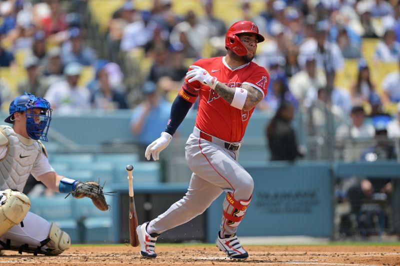 May 18, 2025; Los Angeles, California, USA;  Los Angeles Angels third base Yoan Moncada (5) hits a single in the third inning against the Los Angeles Dodgers at Dodger Stadium. Mandatory Credit: Jayne Kamin-Oncea-Imagn Images